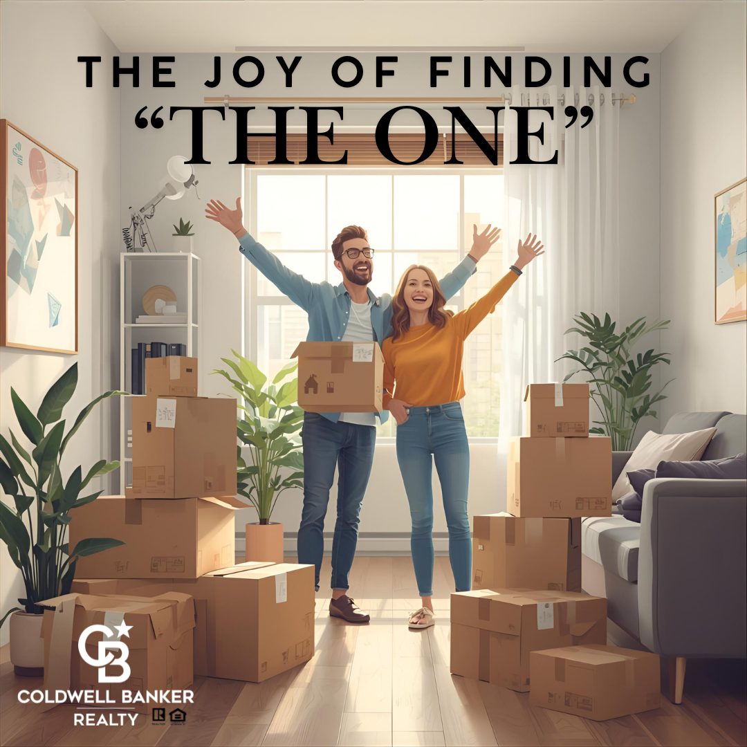 Happy couple celebrating in their new home surrounded by moving boxes, symbolizing the joy of finding “The One” in real estate.