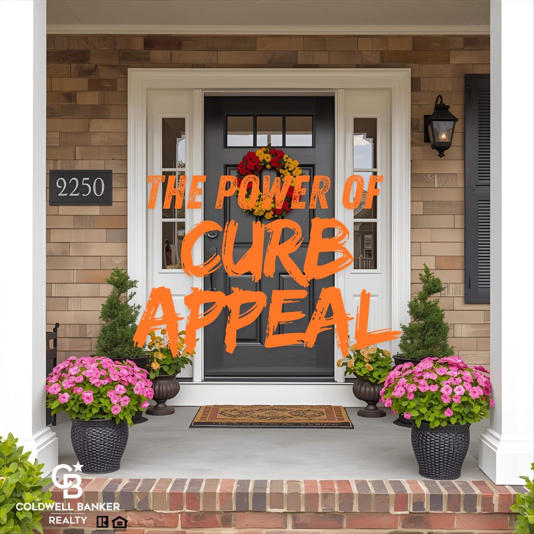 Front porch with a freshly painted black door, colorful flower pots, and a seasonal wreath, showcasing strong curb appeal with the words “The Power of Curb Appeal” displayed in bold orange text.