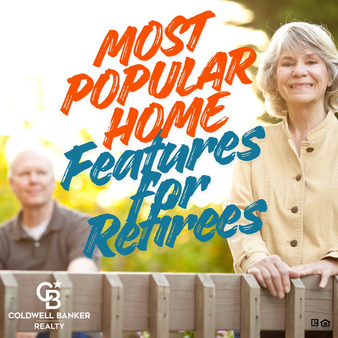 Smiling older woman standing at a wooden fence outdoors with greenery in the background, while a man sits behind her slightly out of focus. Text overlay reads “Most Popular Home Features for Retirees.” Coldwell Banker Realty branding displayed.