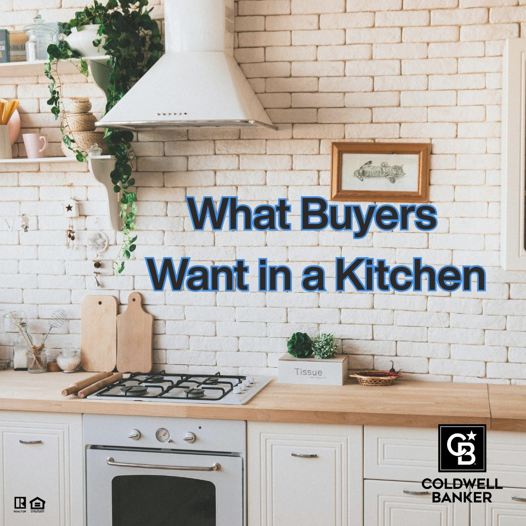Bright modern kitchen with white brick backsplash, wood countertops, gas cooktop, and text overlay reading “What Buyers Want in a Kitchen,” featuring Coldwell Banker branding.
