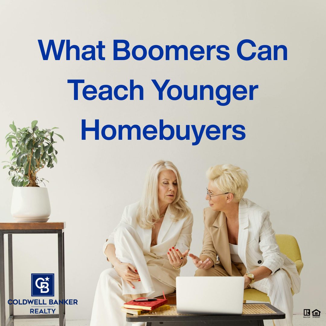 Two mature professionals discussing homebuying strategies while reviewing information on a laptop, illustrating lessons older generations can teach younger homebuyers.