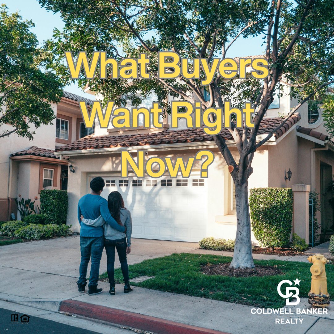 Couple standing in front of a modern suburban home, representing what today’s home buyers want most in the current real estate market